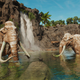 Two statues of wooly mammoths stand in a lake in Far Cry 6.